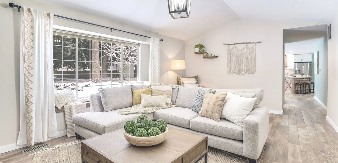 White living room with a white sofa and wooden table in a winter season